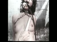 While being whipped and hanging naked this sluts wrists begin to bleed from bdsm restraints